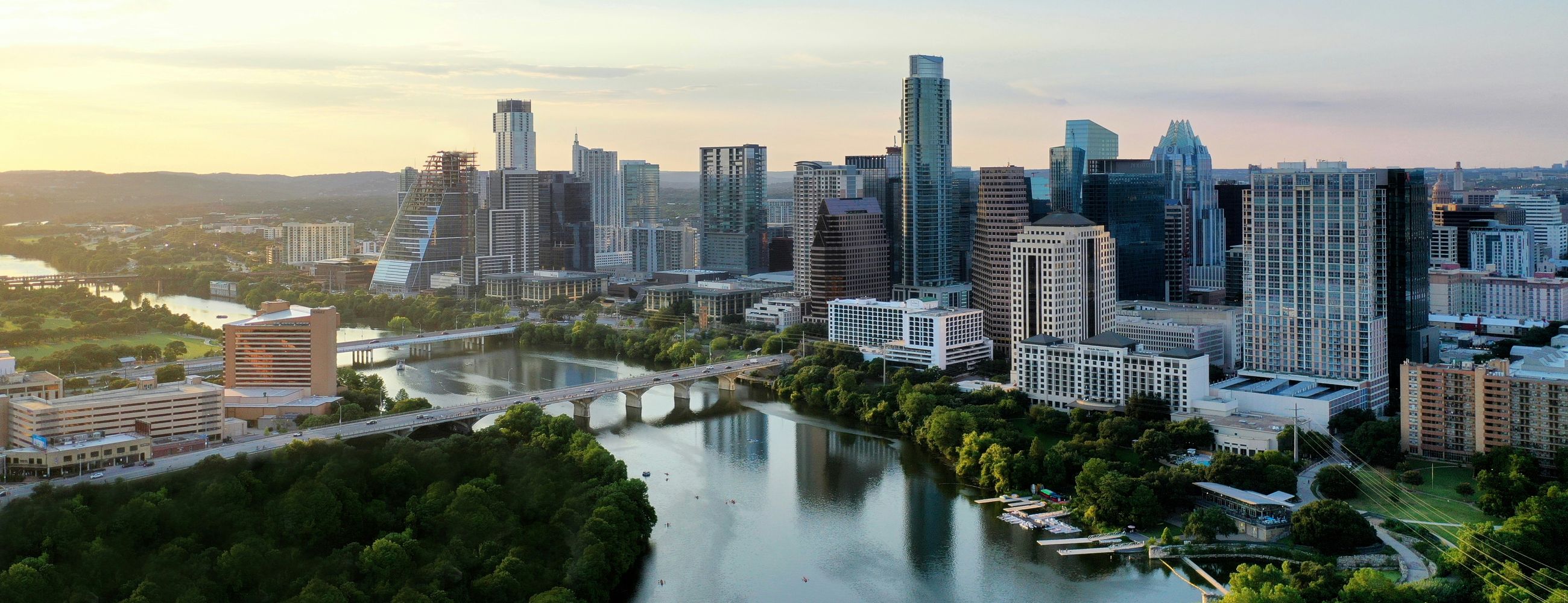 Downtown Austin at sunset, the Colorado River curving past the skyline